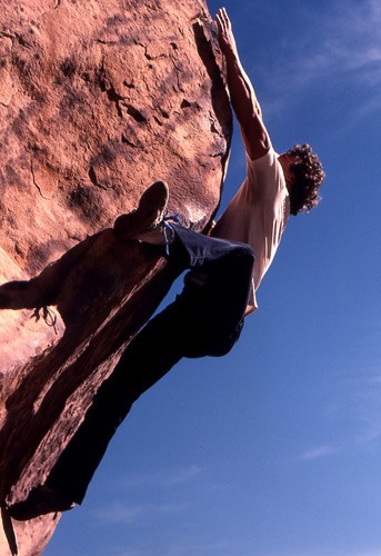 John Long fires a dyno while bouldering in tennis shoes, Willow Spring...