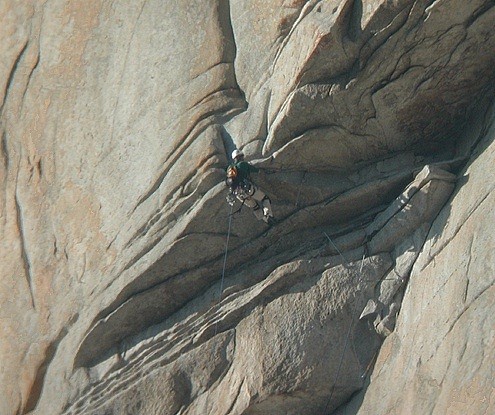 A climber turning the lip of the airy Roof on the Salathé Wall. This i...