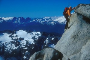 Mark Kroese bouldering near the summit of a peak in the Cascades, Wash...