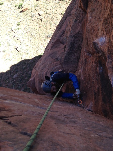 Joe cleaning the upper thing corner of the crux pitch.