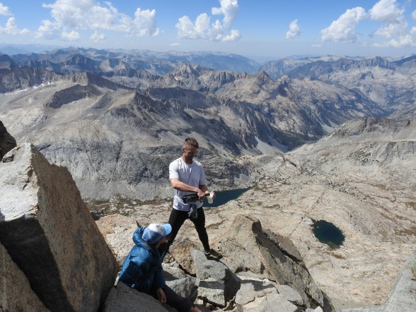 Casey opening bottle of Champagne on Middle Palisade summit to celebra...