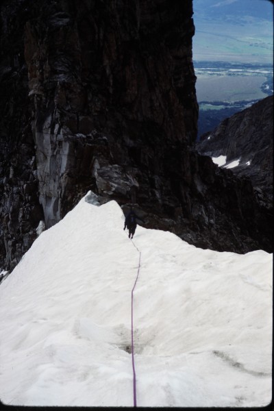 Gingerly crossing the snow ridge between the Dike pinnacle and the mai...